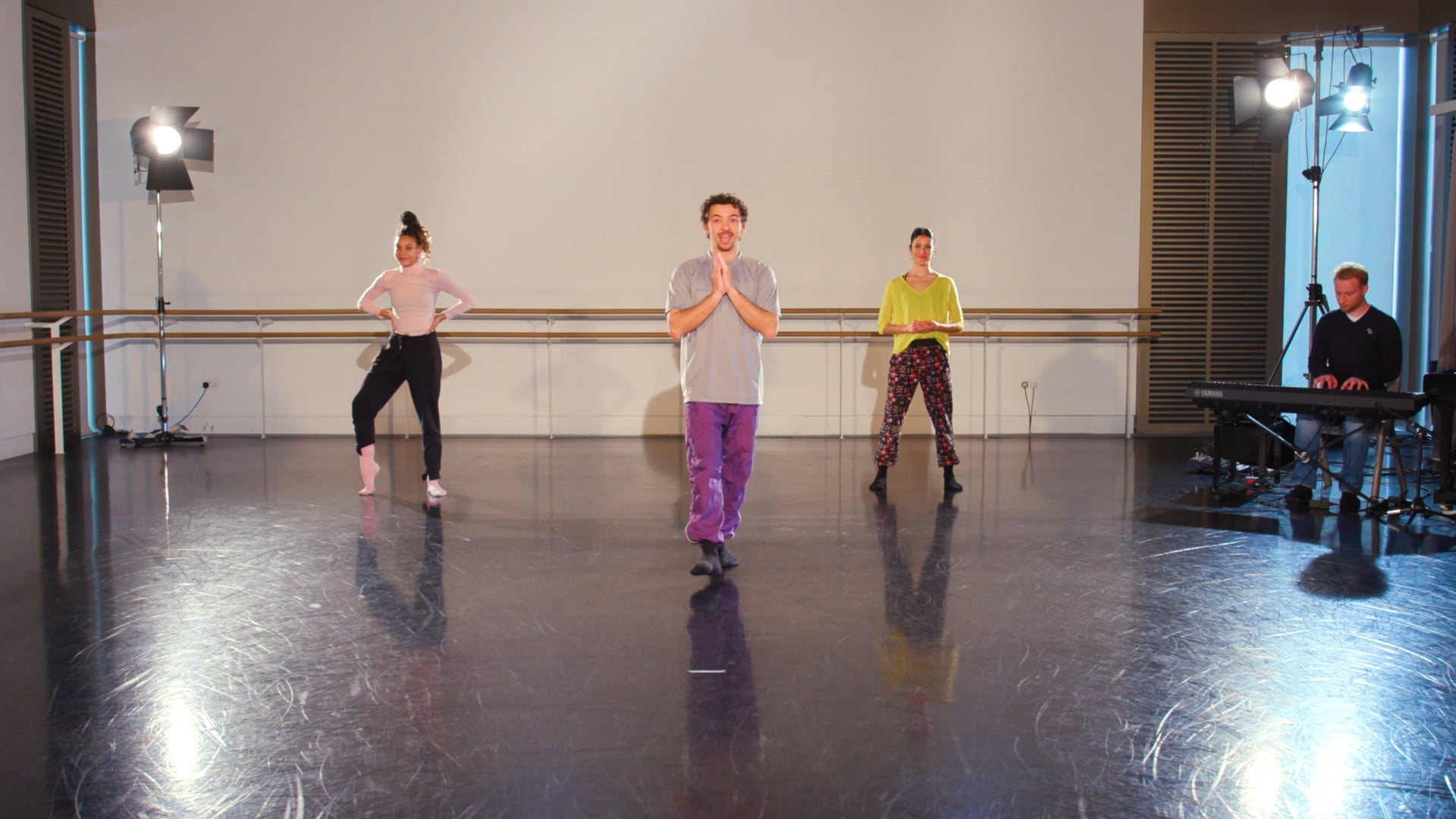 a group of people standing on top of a dance floor.