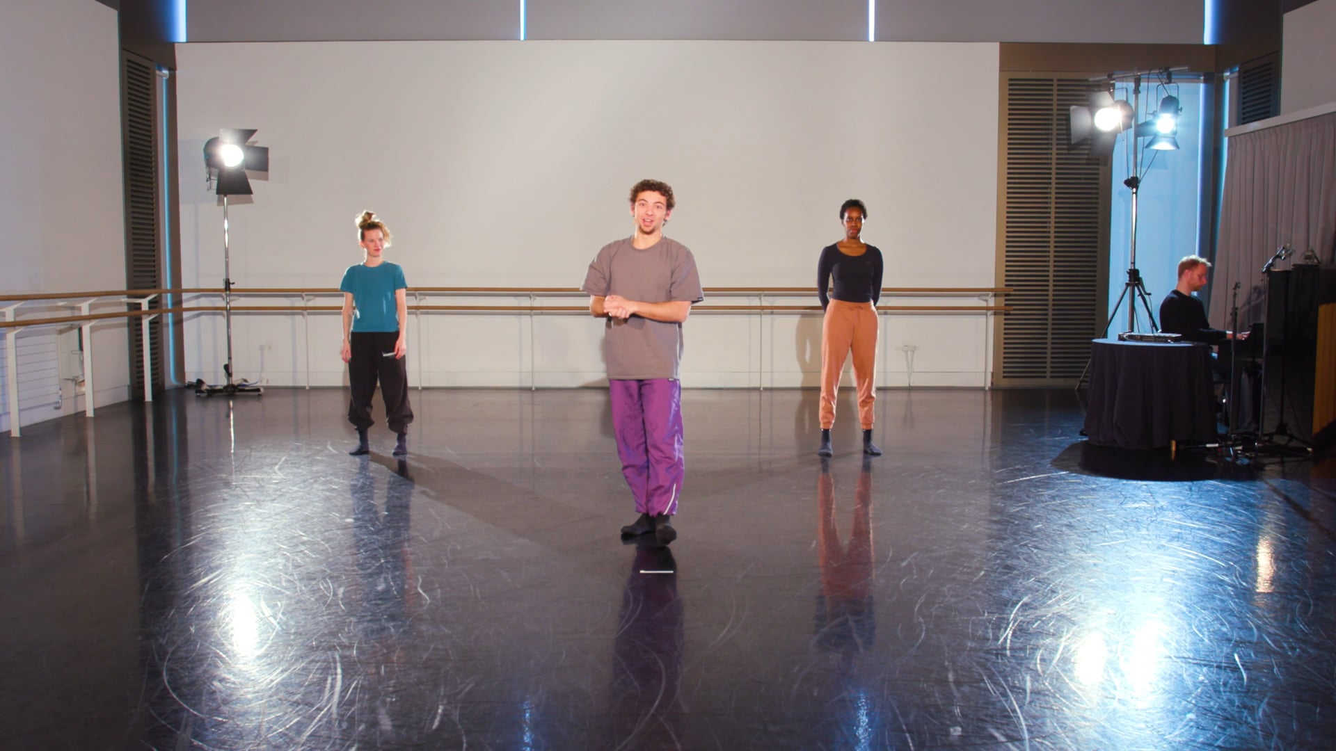 a group of people standing on a dance floor.