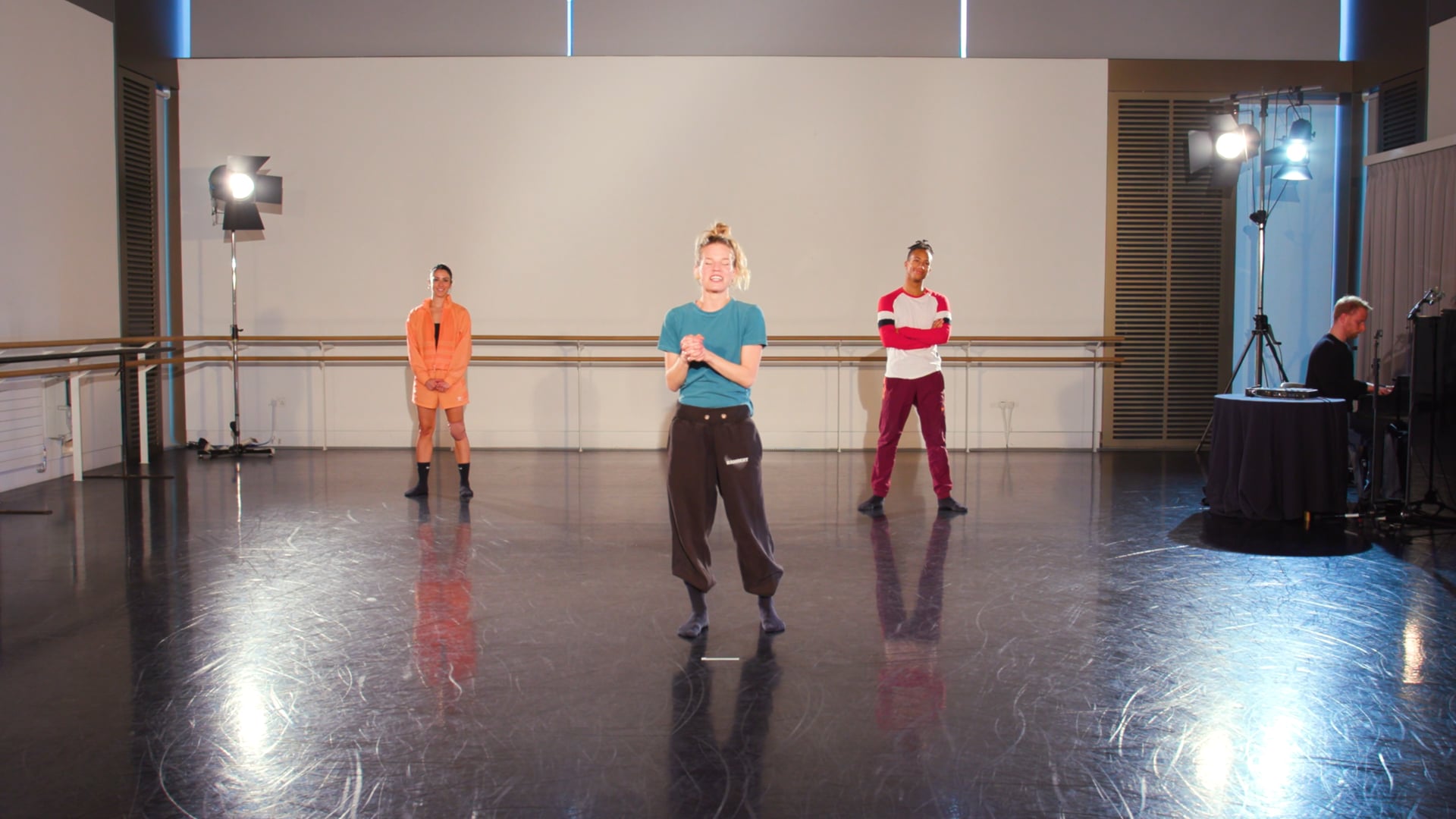 a group of people standing on top of a dance floor.