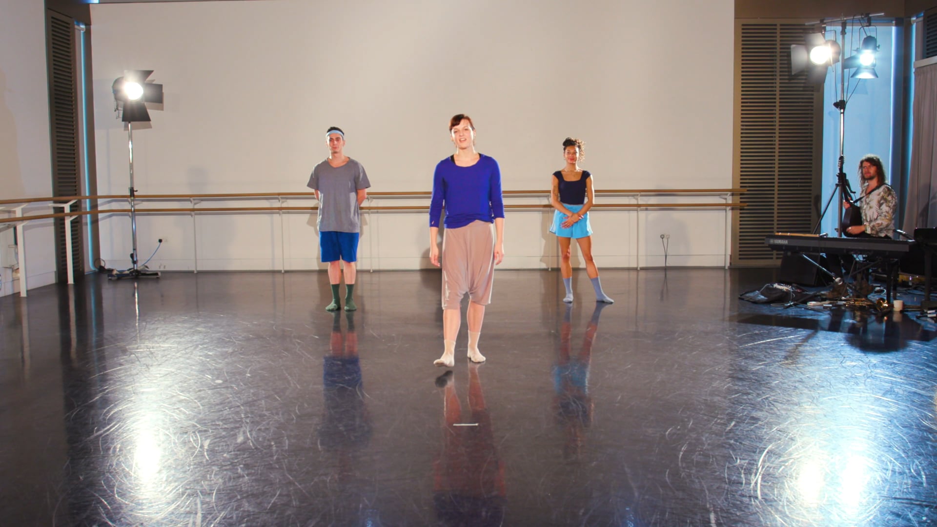 a group of people standing on a dance floor.
