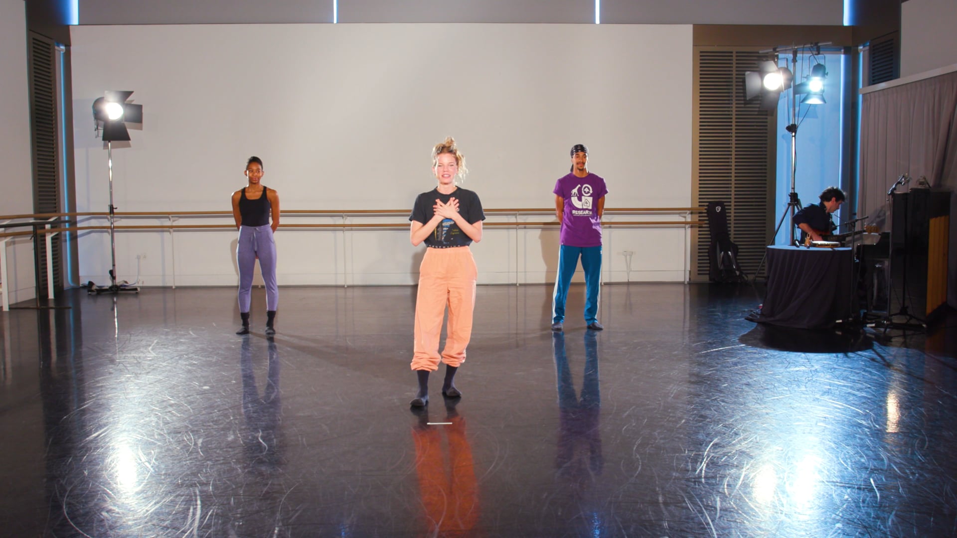 a group of people standing on top of a dance floor.