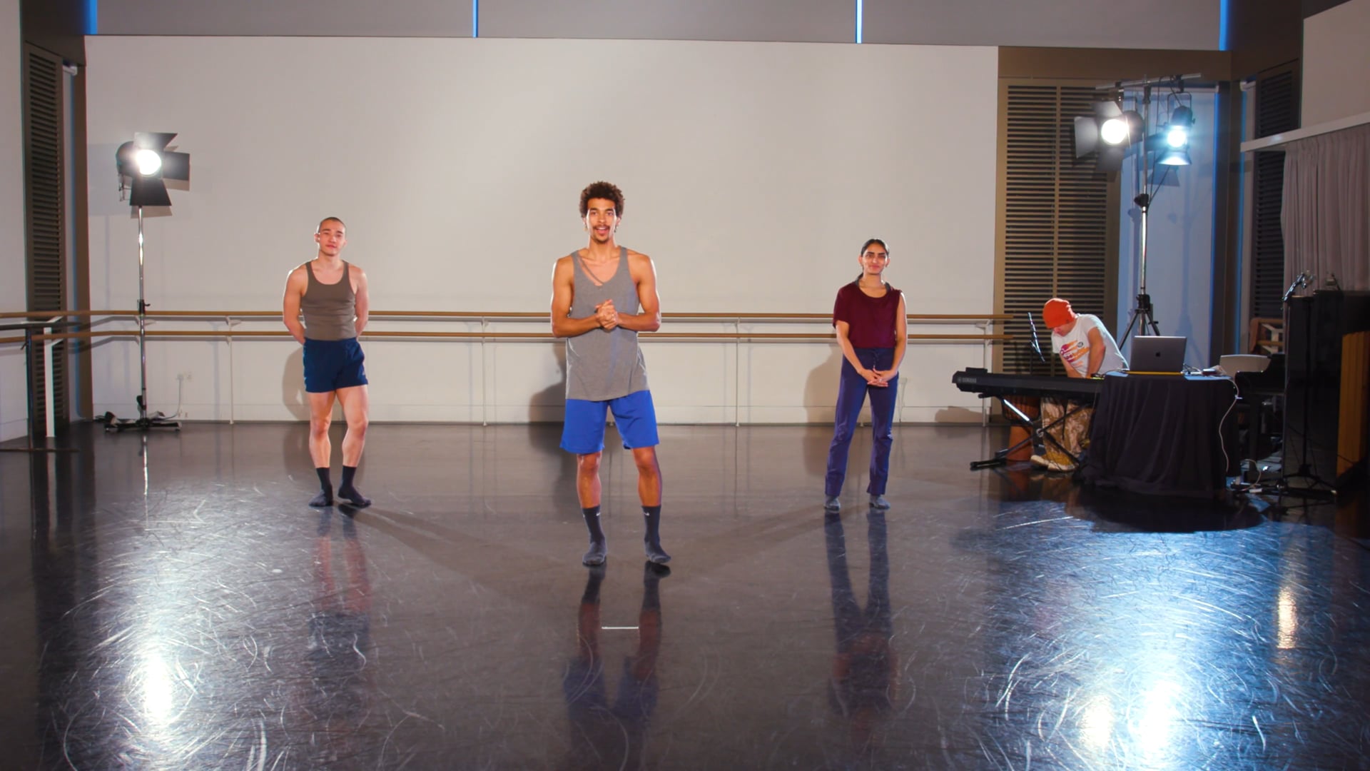 a group of young men standing on top of a dance floor.