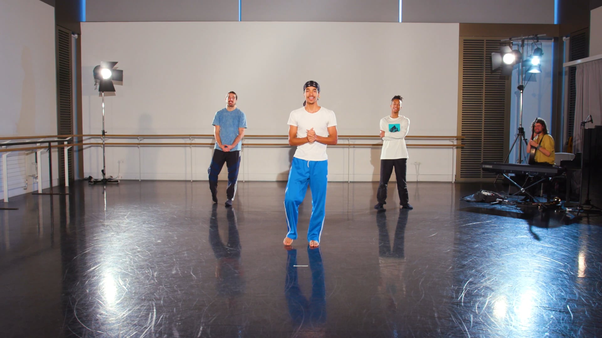 a group of men standing on top of a dance floor.