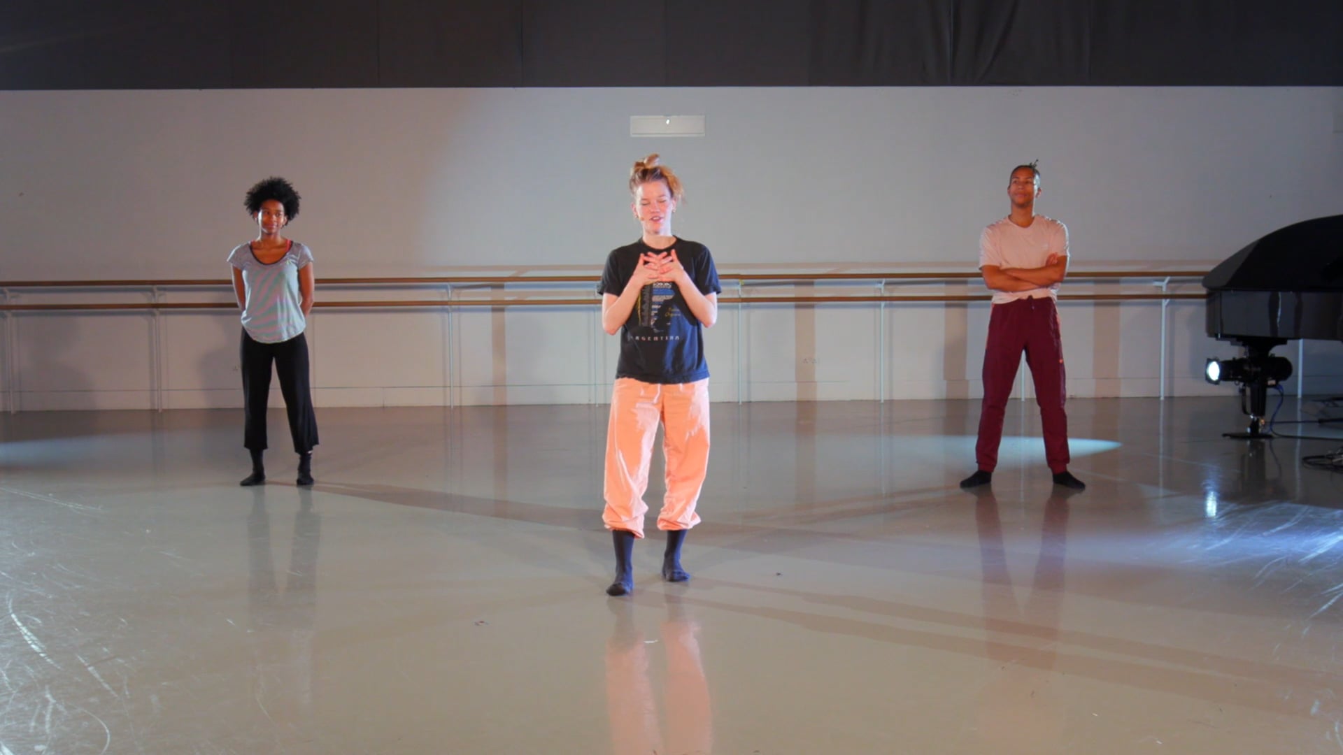 a group of young men standing on top of a dance floor.