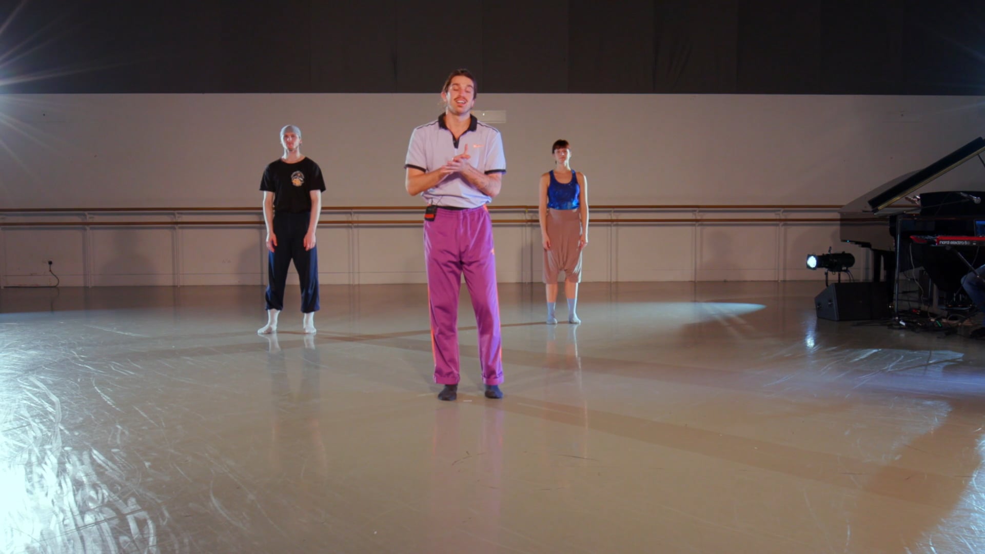 a group of people standing on top of a dance floor.