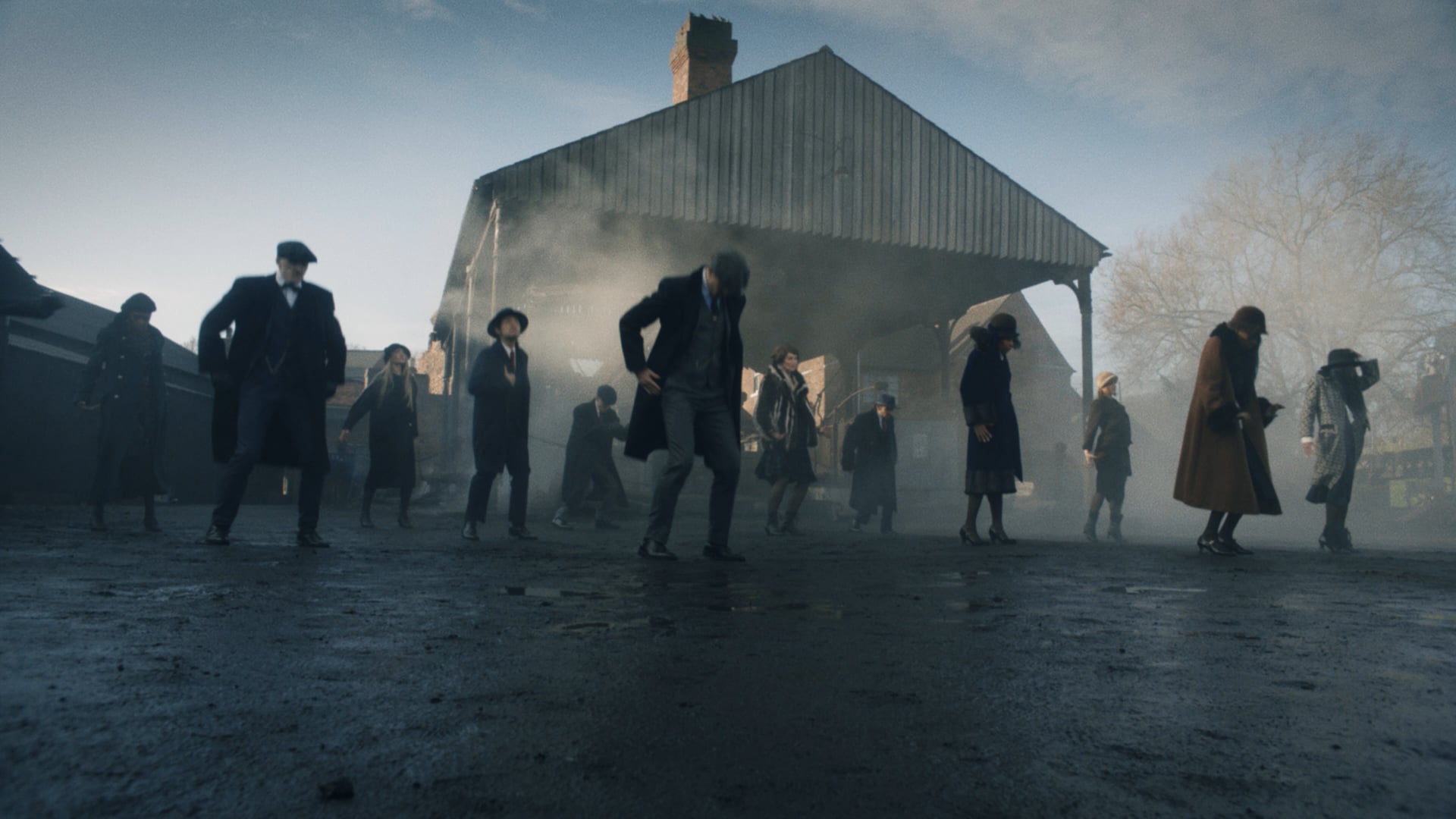 a group of people standing in front of a building.