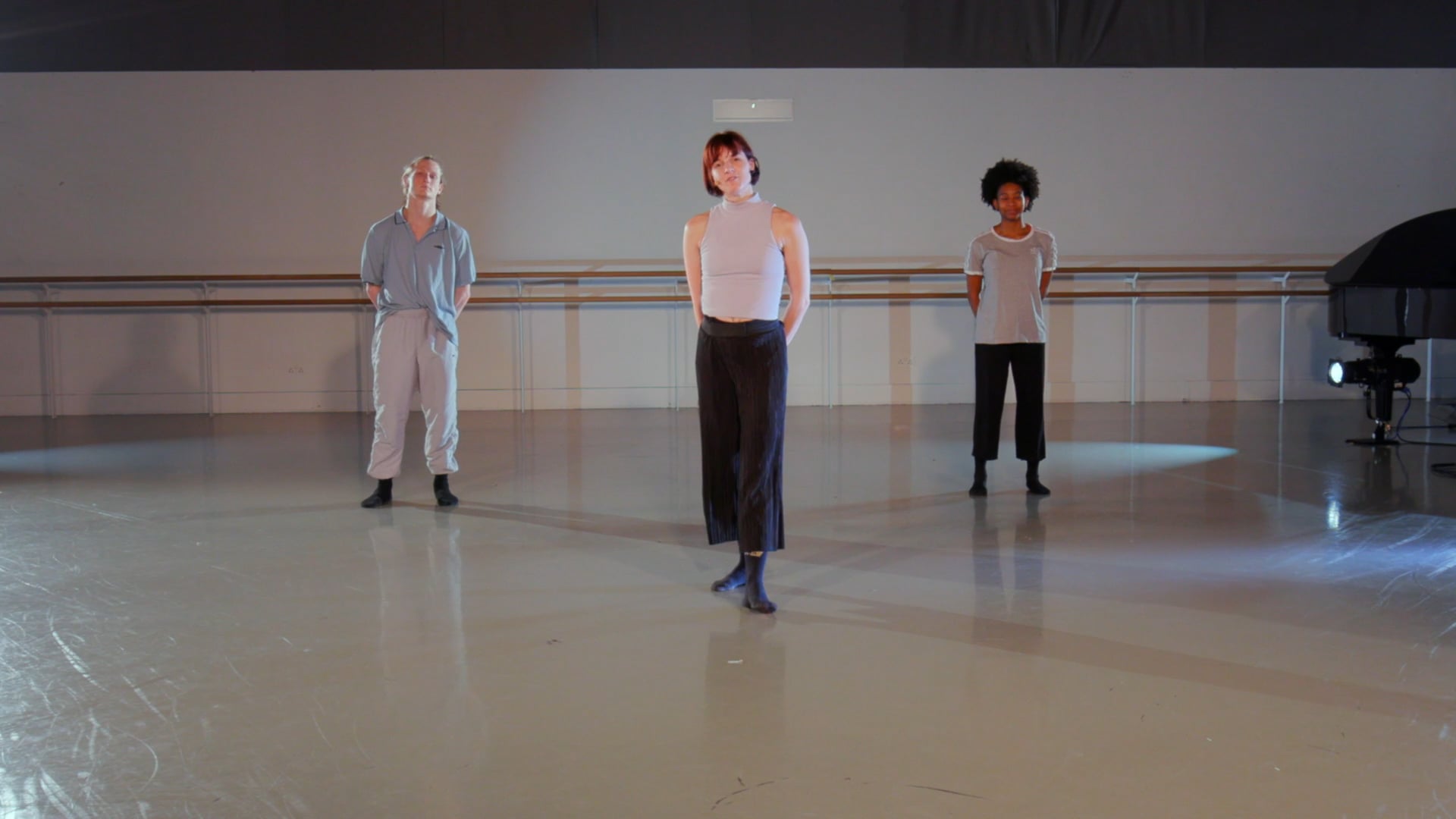 a group of people standing on a dance floor.