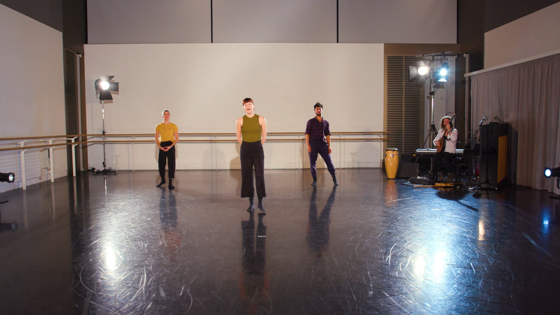 a group of people standing on top of a dance floor.