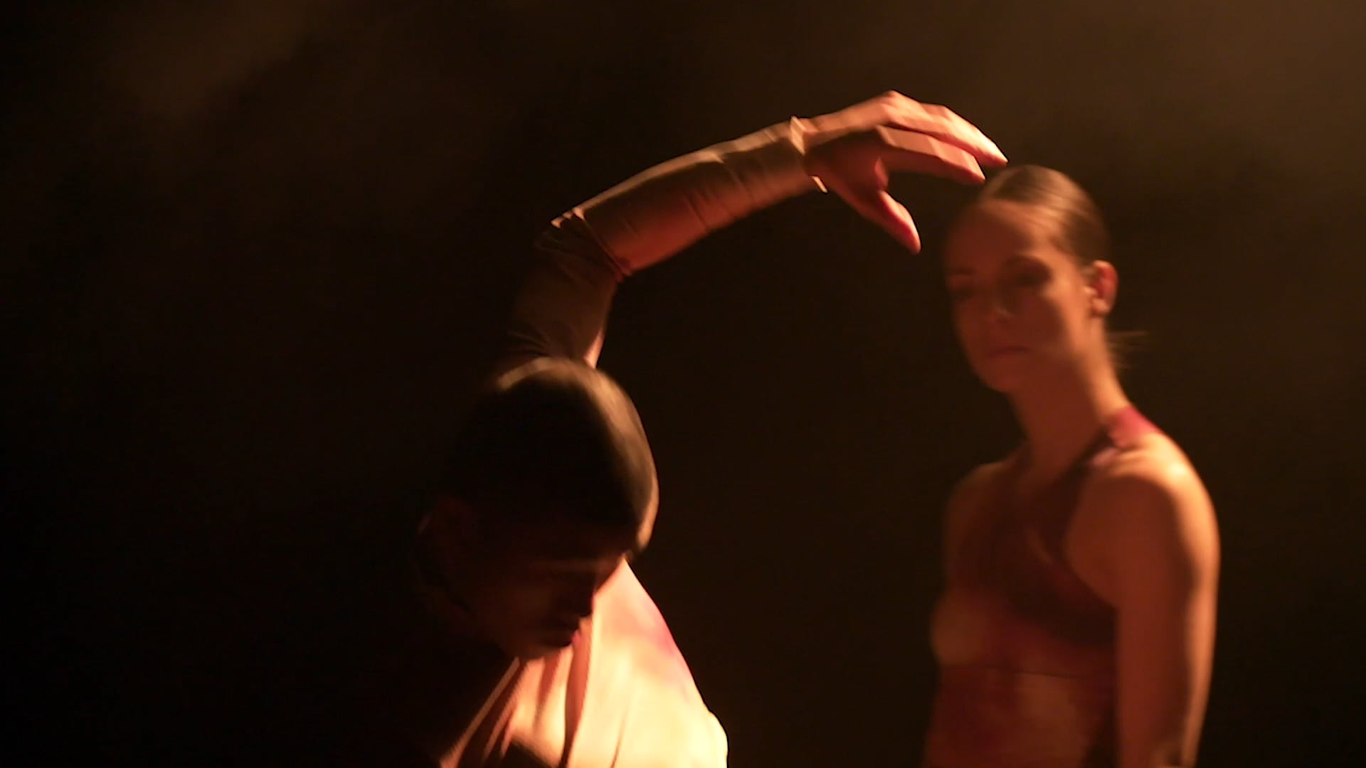a woman standing next to a man on a stage.