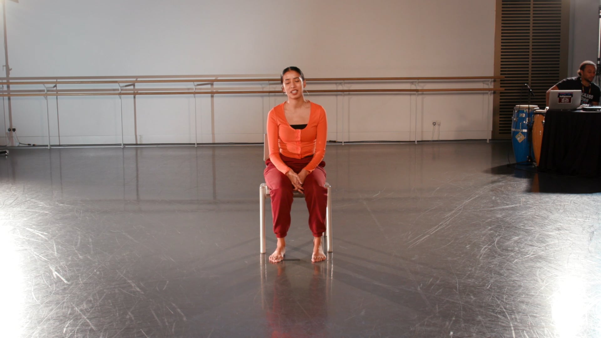 a woman sitting on a chair in a room.