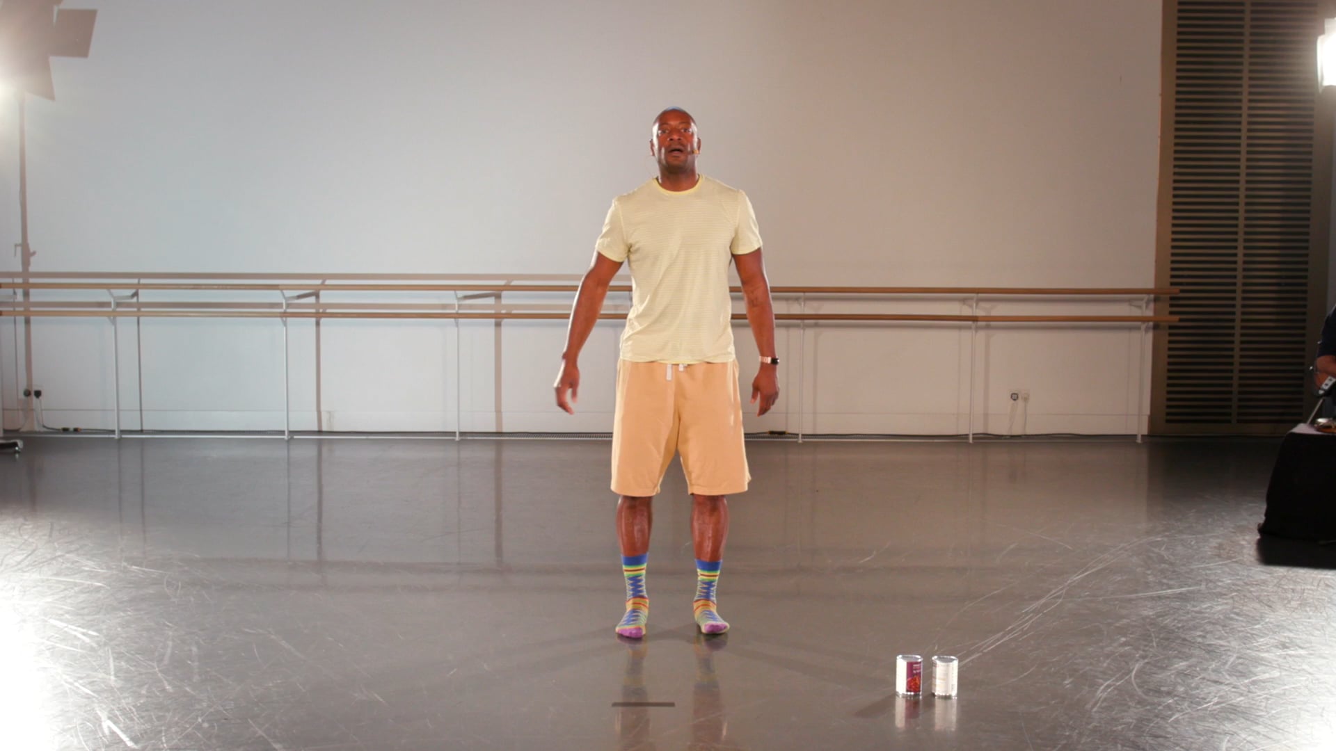 a man in a white shirt and yellow shorts.