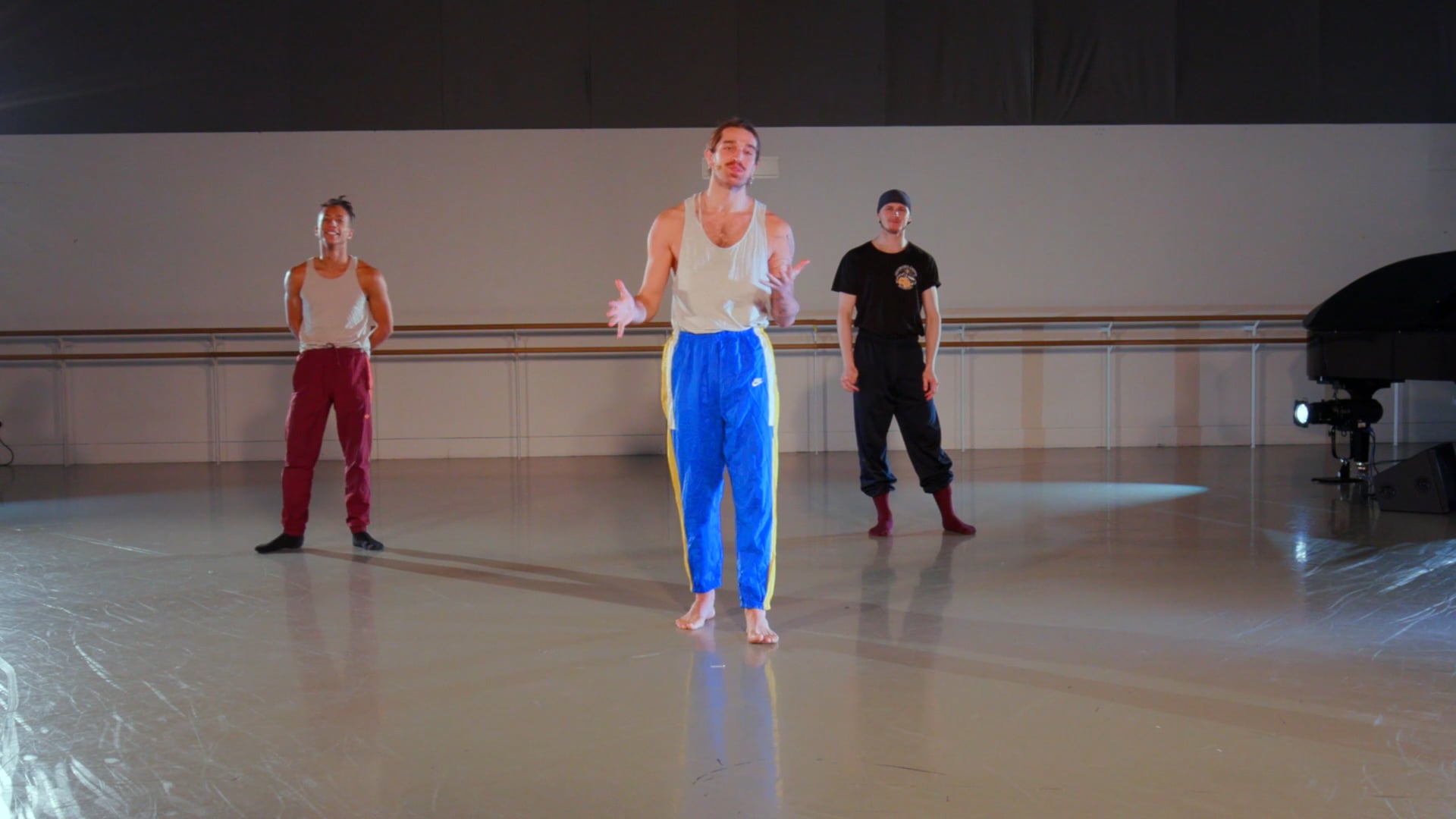 a group of young men standing on top of a dance floor.