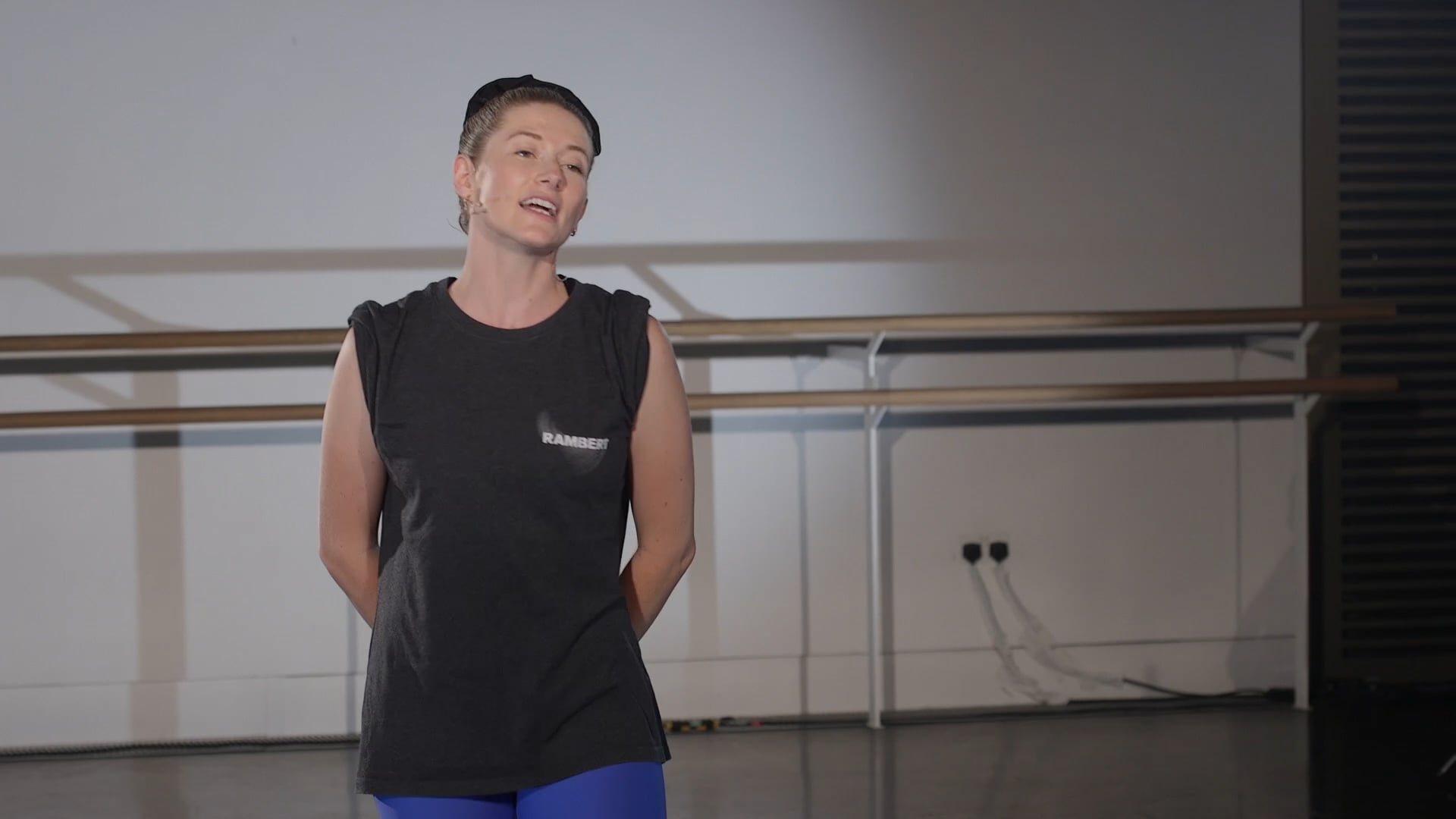 a woman in a black shirt and blue pants.