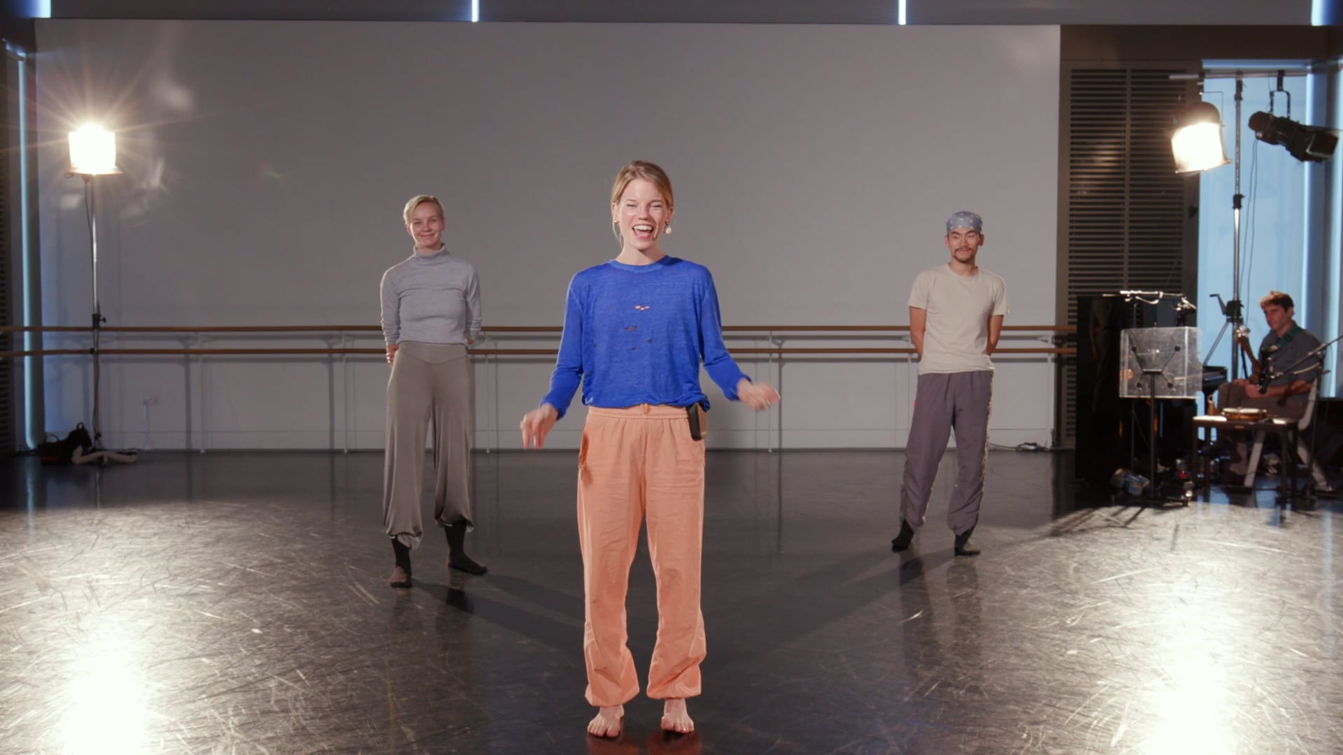 a group of people standing on top of a dance floor.