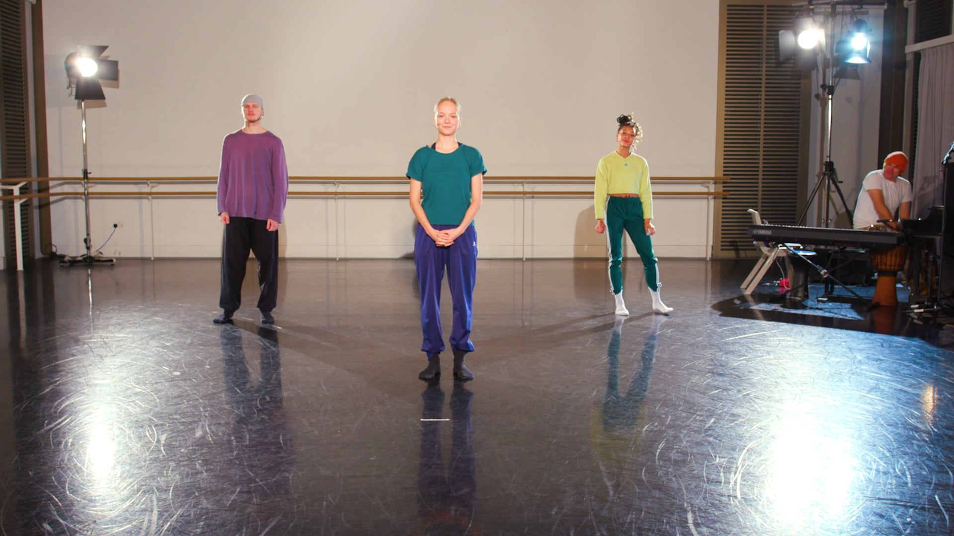 a group of people standing on top of a dance floor.