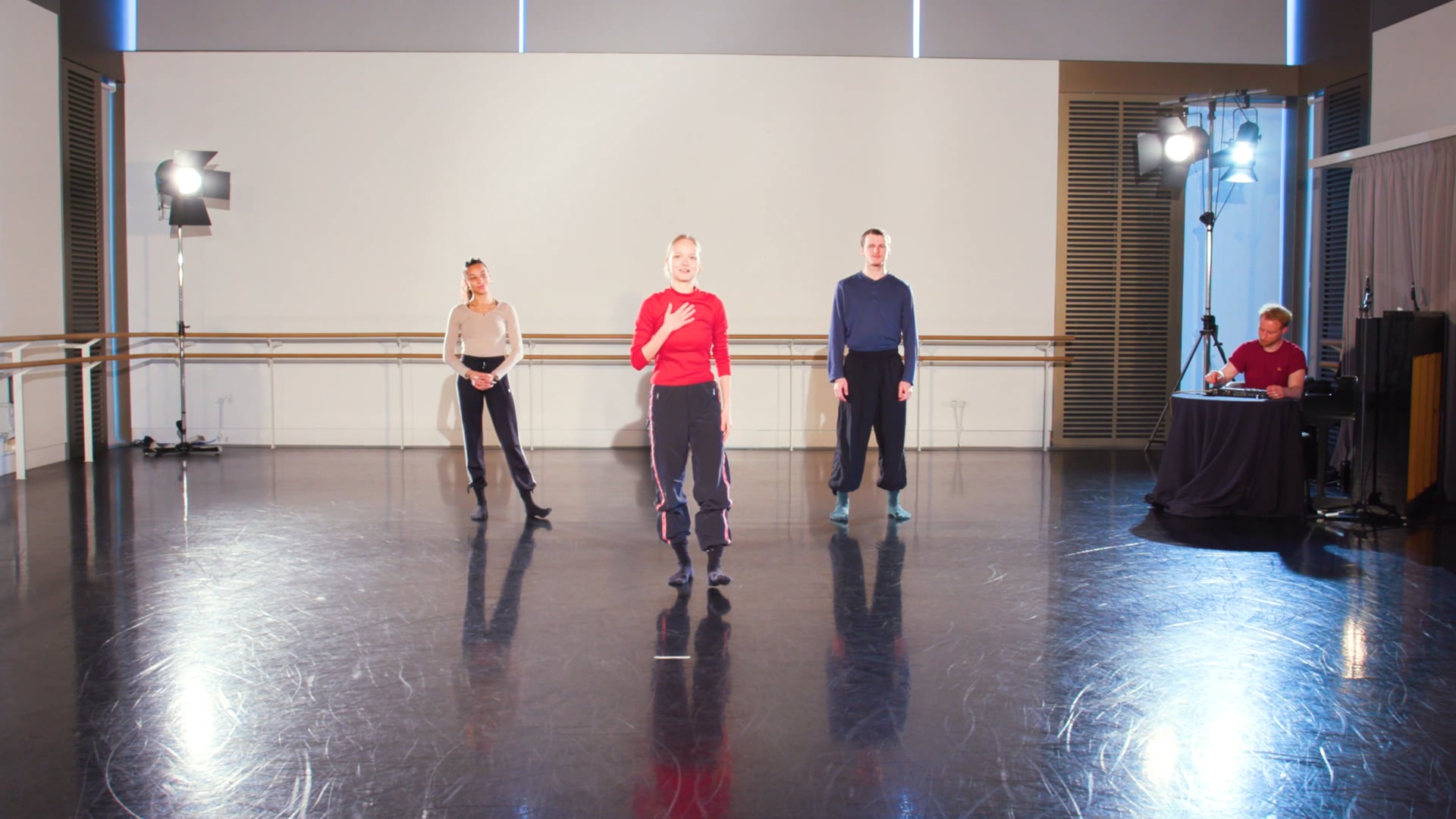 a group of people standing on top of a dance floor.