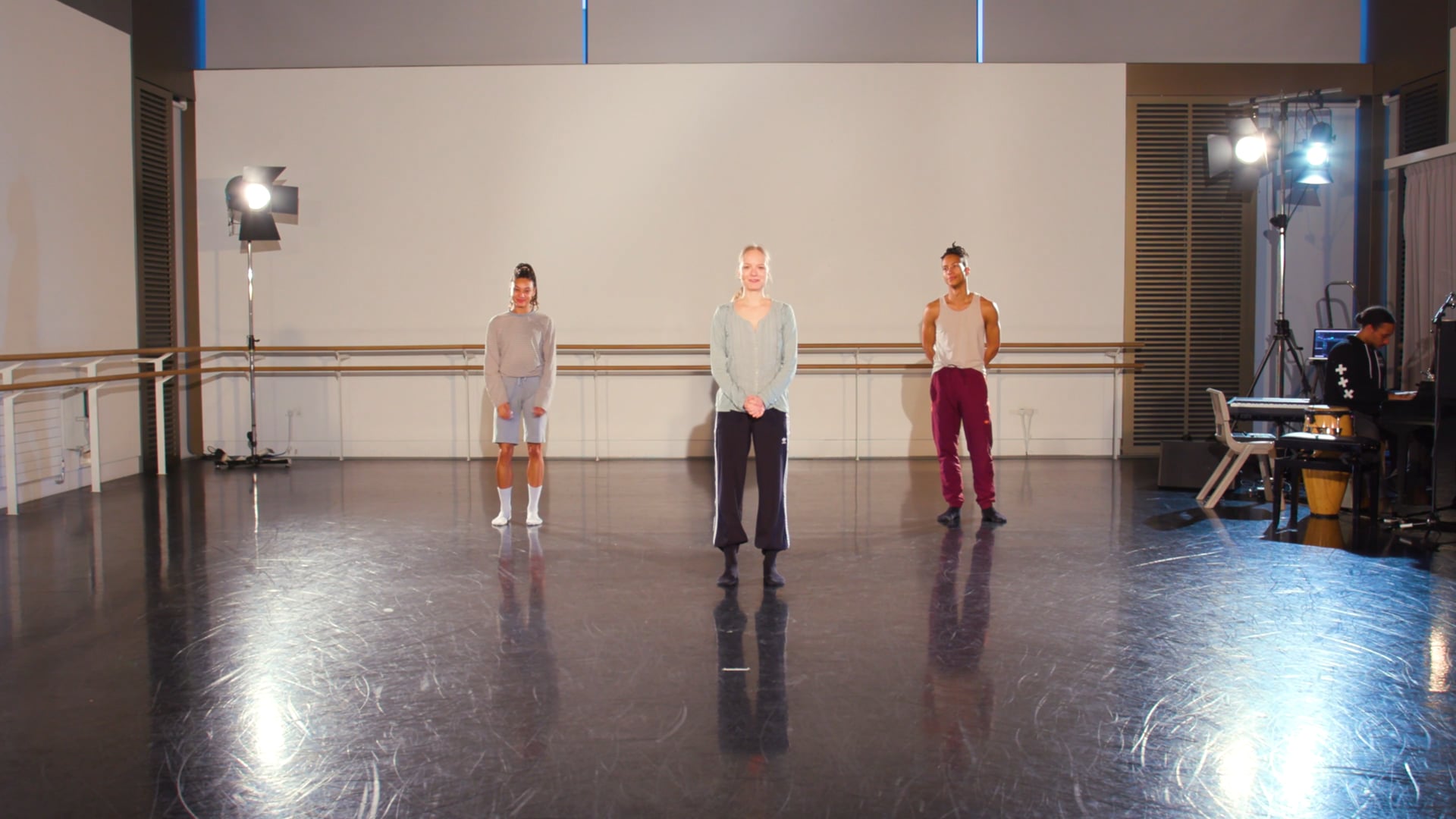 a group of men standing on top of a dance floor.