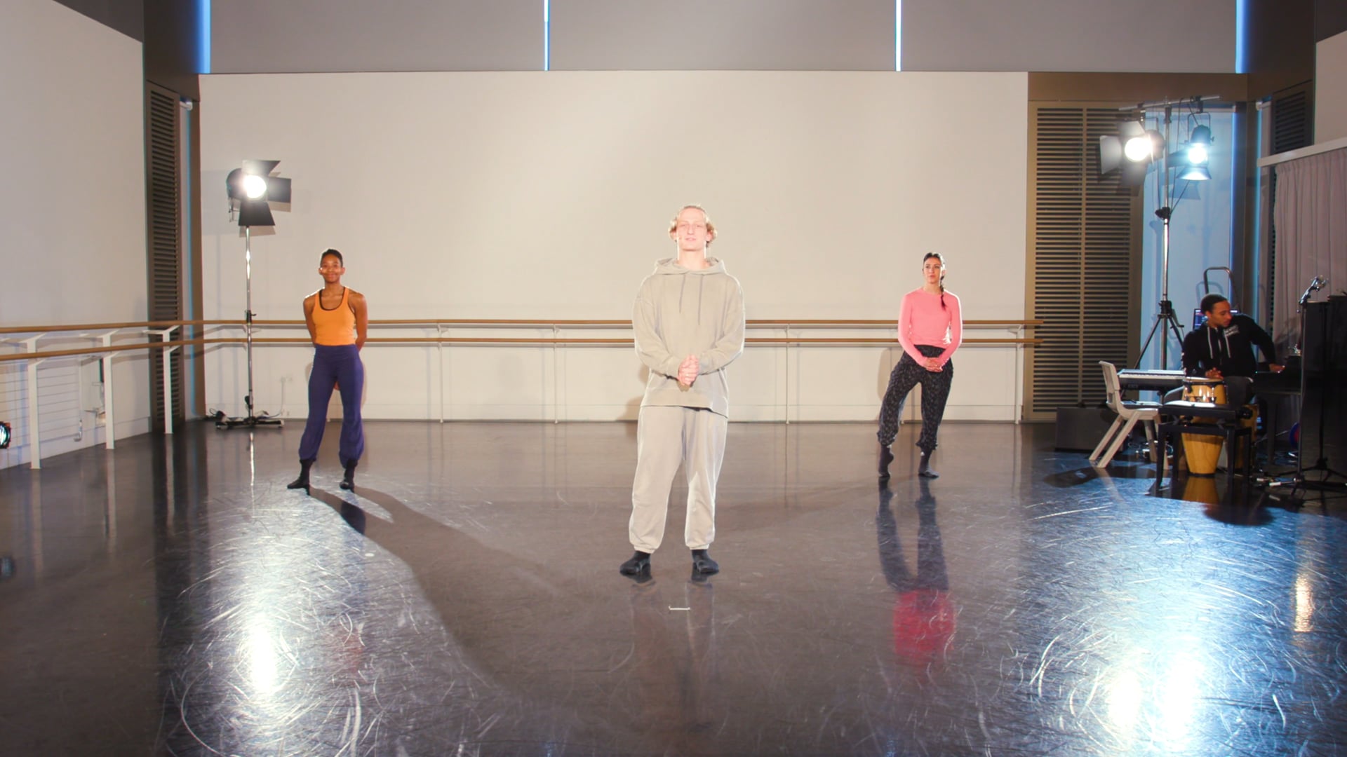 a group of people standing on a dance floor.