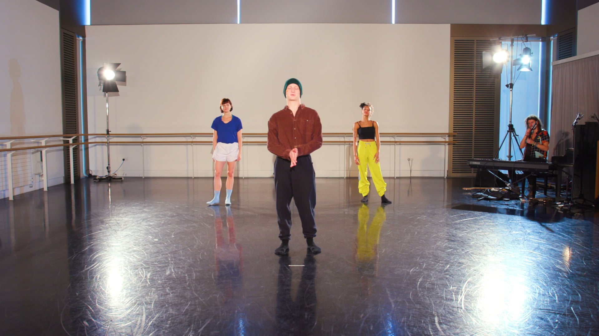 a group of people standing on a dance floor.