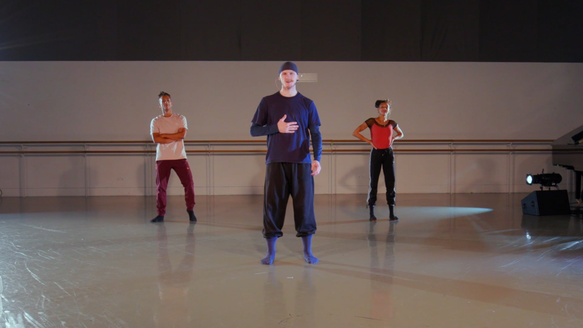 a group of people standing on top of a dance floor.