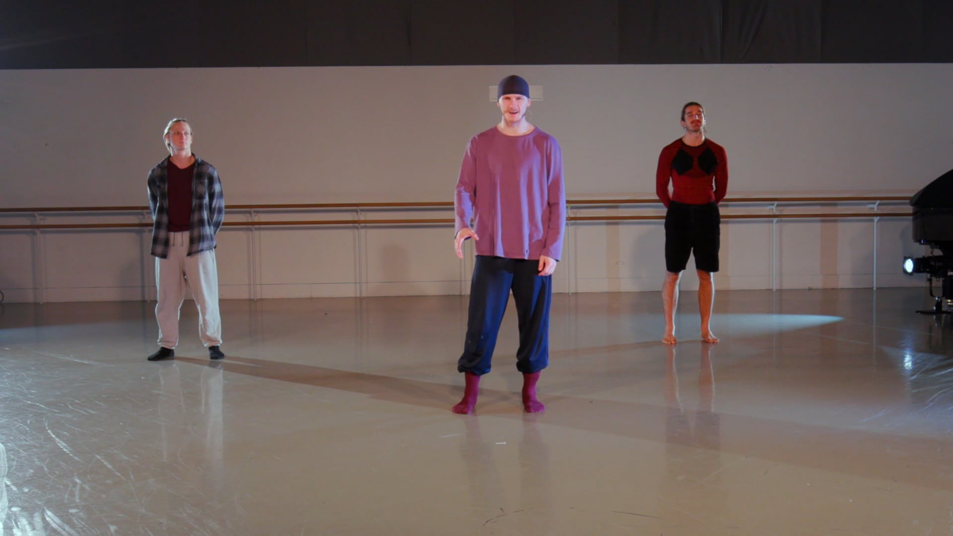 a group of people standing on a dance floor.