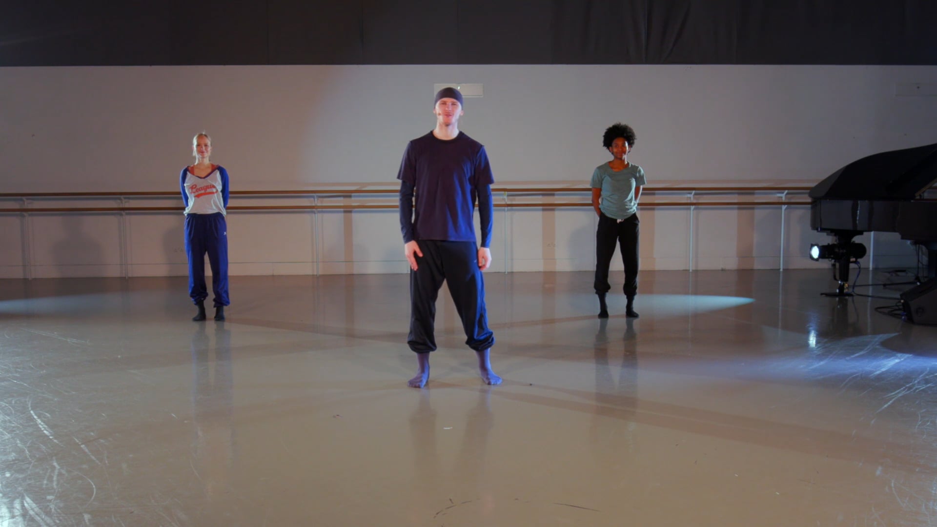 a group of people standing on top of a dance floor.