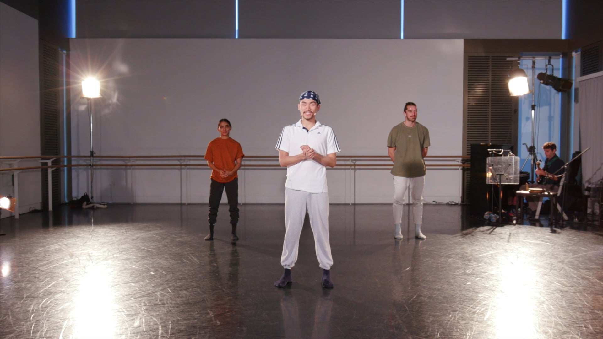 a group of men standing on top of a dance floor.