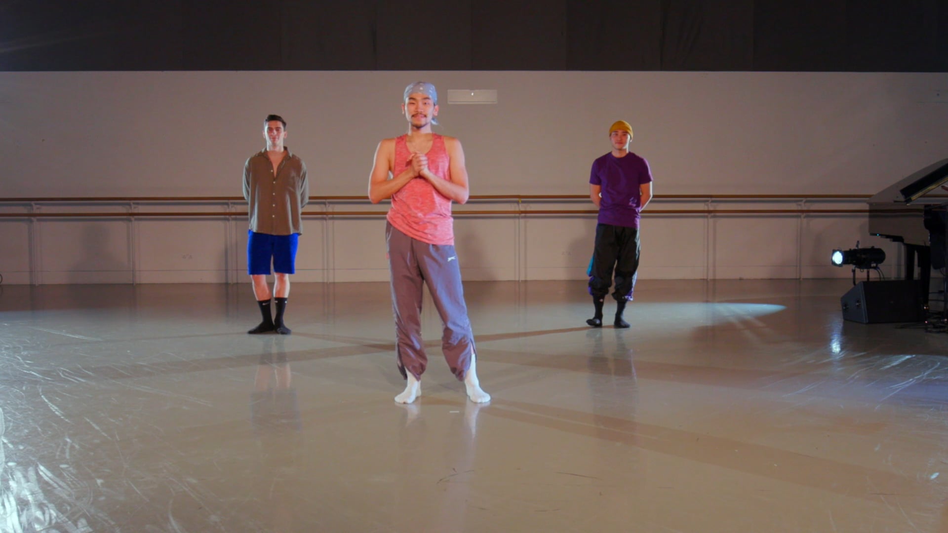 a group of people standing on a dance floor.