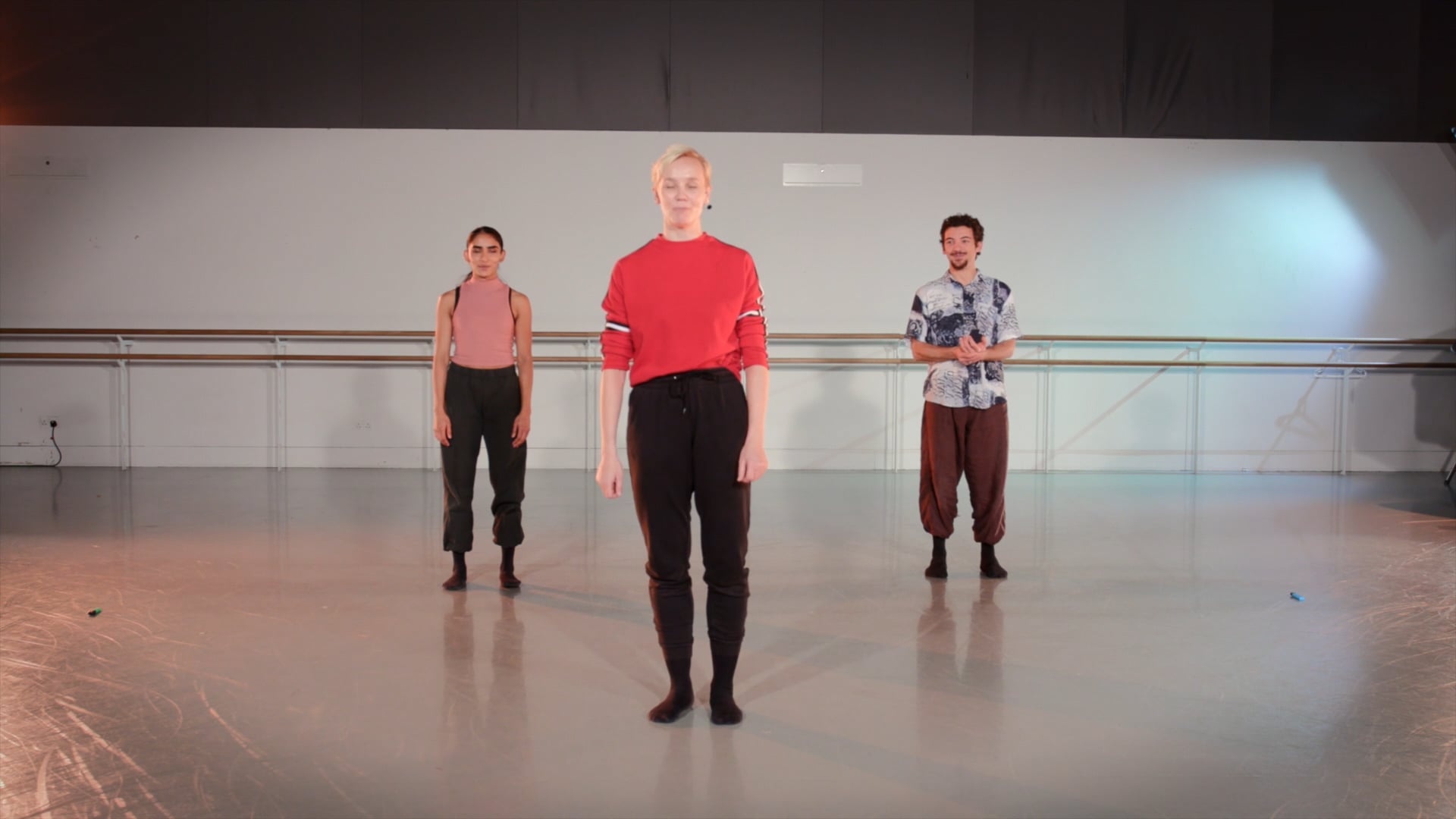 a group of men standing on top of a dance floor.