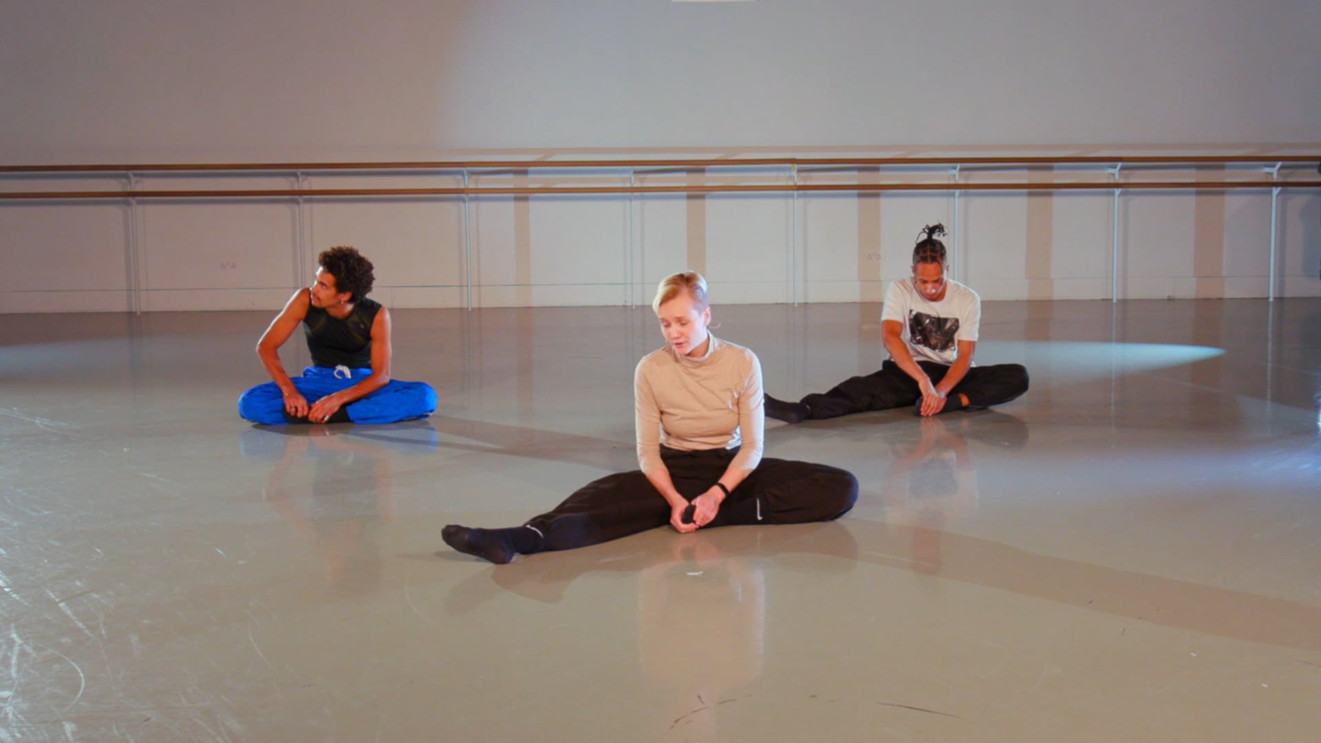a group of people sitting on the floor in a room.