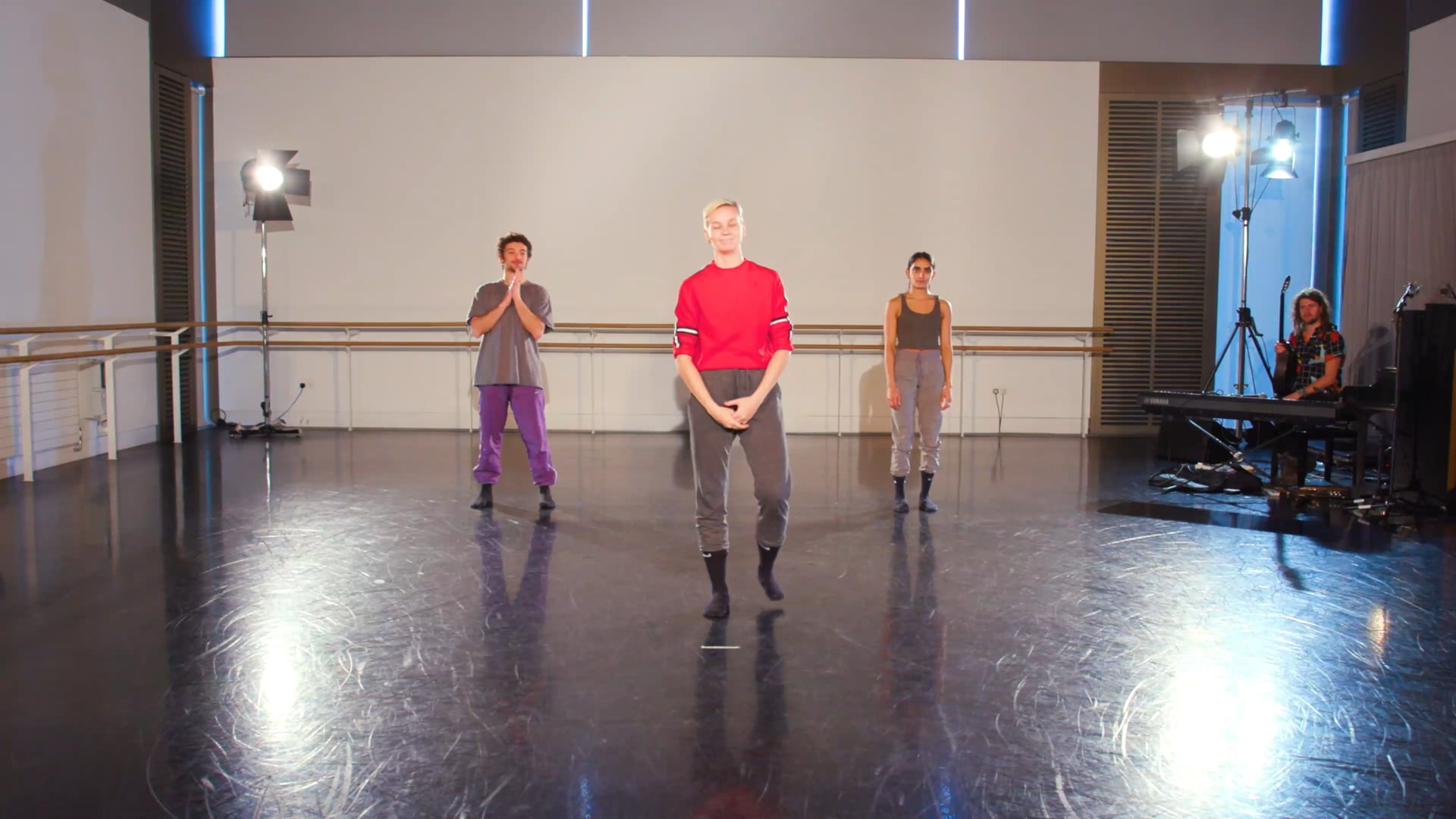 a group of people standing on top of a dance floor.