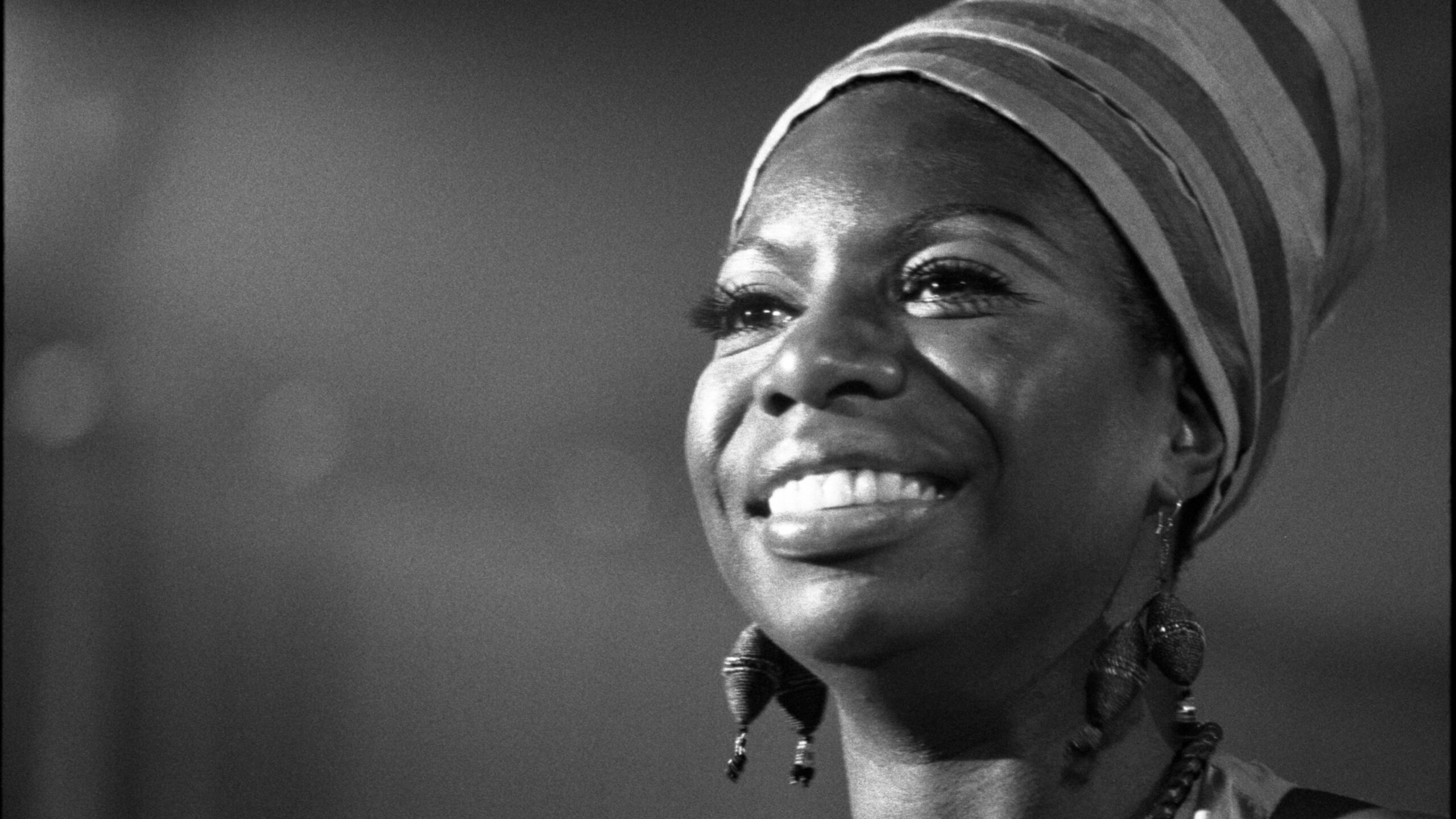 a black and white photo of a woman wearing a turban.