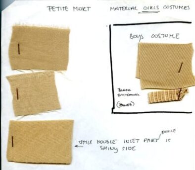 A page with three beige fabric swatches pinned on the left labeled "Girls Costumes," and one beige swatch labeled "Boys Costume" to the right, with handwritten notes about material and stitching.
